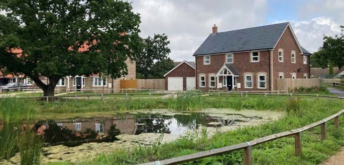 Image of Housing by pond